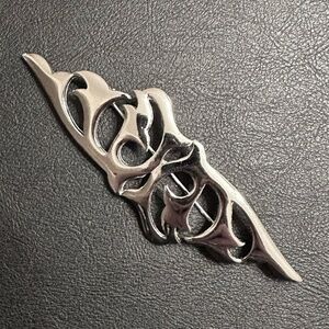 Vintage Ginnie Johansen silver-tone scrollwork brooch